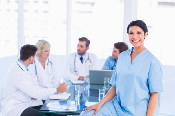 istock Smiling female surgeon with colleagues in meeting 836077246