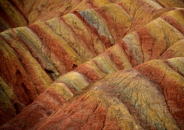 Danxia landform geological park, Zhangye, Gansu, China Close-up at the first viewing platform at the Danxia landform geological park near the town of Zhangye. Known for its colorful rock formations, Zhangye Danxia has unusual colours of the rocks, which are smooth, sharp and in layers. They are the result of deposits of sandstone and other minerals that occurred over 24 million years. Gansu province, China zhangye danxia geopark china stock pictures, royalty-free photos & images
