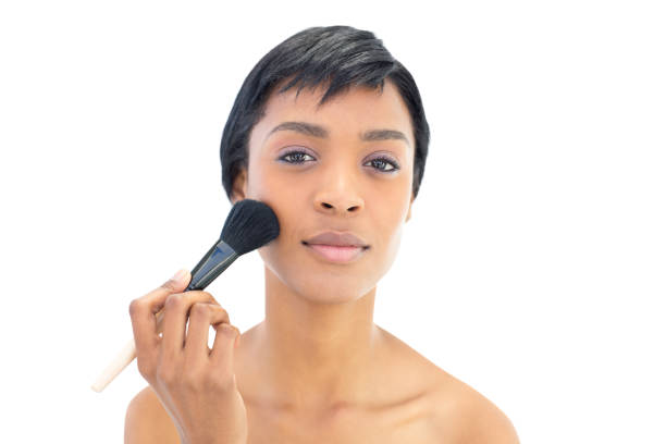 istock Beautiful black haired woman applying powder on her cheeks 836083208