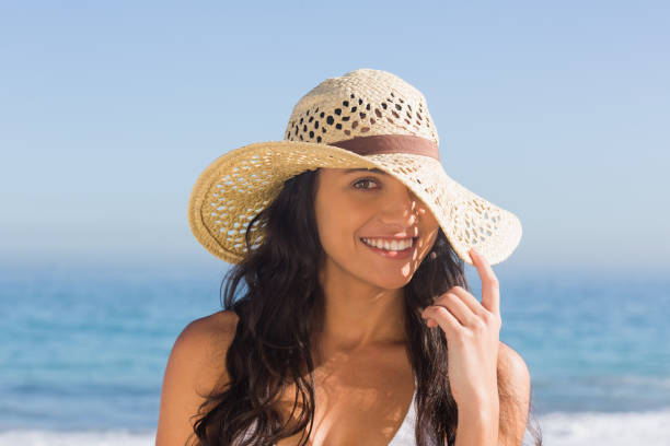 istock Attractive dark haired woman with straw hat posing 836083772