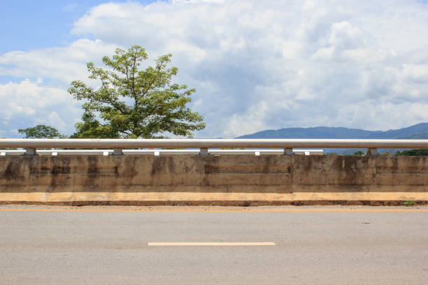Side of road with tree and clouds sky background.