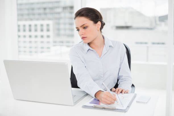 istock Businesswoman with graphs and laptop in office 836084332