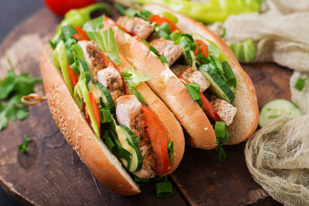 istock Big sandwich with chicken breasts, tomato, cucumber and herbs. 836084592