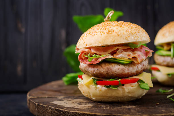 istock Big sandwich - hamburger burger with beef, cheese, tomato, cucumber and fried bacon. 836091374