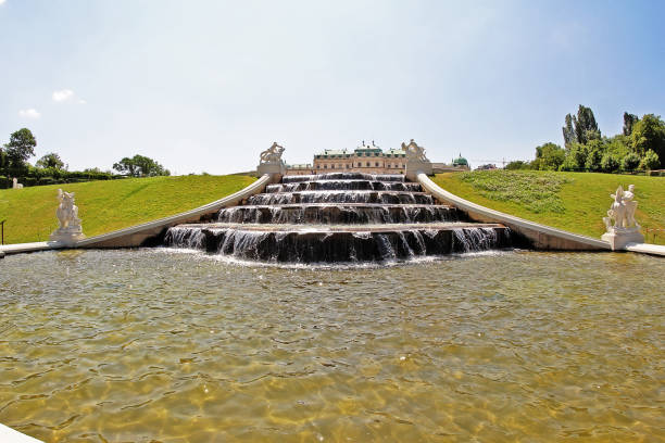 Saint Petersburg, Russia - July 29, 2012: Tourists visiting the Peterhof Palace gardens (built in 18th century) which are a series of palaces and gardens, laid out on the orders of Peter the Great. The palace-ensemble along with the city centre is recognised as a UNESCO World Heritage Site. Upon the bluff's face below the Palace is the Grand Cascade (Bolshoi Kaskad). This and the Grand Palace are the centrepiece of the entire complex.