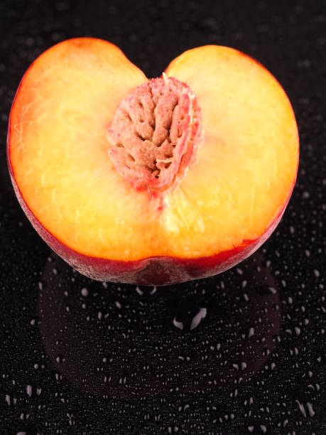 istock Peach on a dark background with droplets 836094284