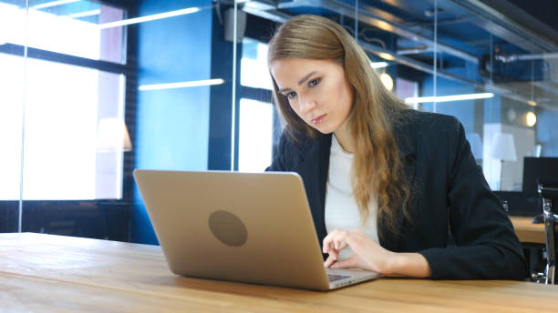 istock Pensive Woman Thinking and Working on Laptop 836094396