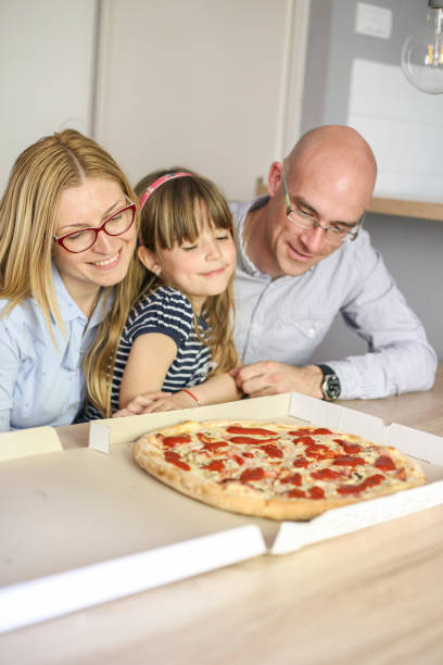 istock Family eating pizza 836095588