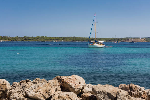 istock Boat sailing on turquoise mediterranean waters 836099016