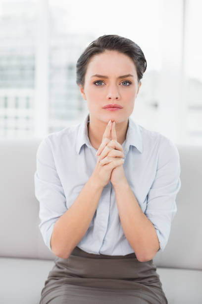 istock Serious elegant young woman sitting at home 836101932