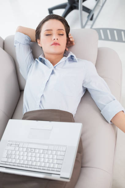 istock Woman with laptop lying on sofa at home 836102244