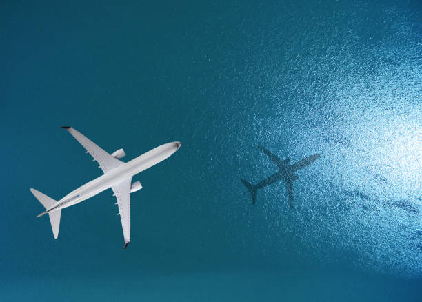 Airplane flies over a sea stock photo