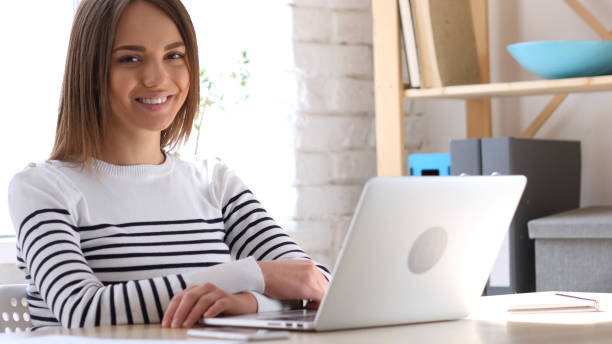 istock Smiling Beautiful Young Woman at Work 836102594