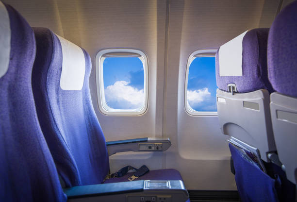 istock View of the sky and clouds with sunlight from the airplane window,empty seats. 836102828