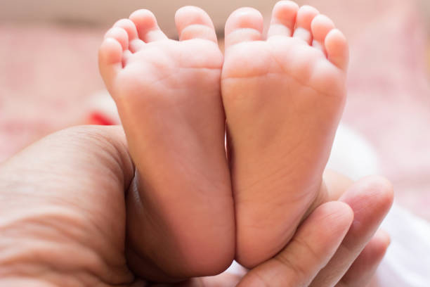 istock Baby Feet on Hand 836102892
