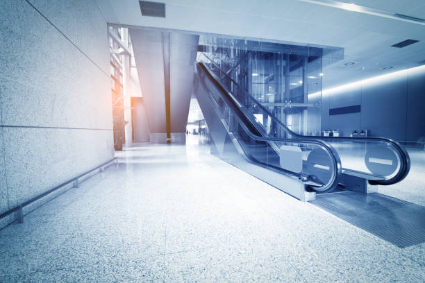 istock escalator of modern office building, blue toned images. 836103164