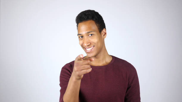 istock Smiling Young Black Man Pointing with Finger, Toward Camera 836112898