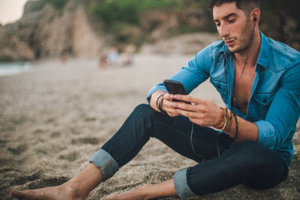 istock Listening music on the beach alone 836113088