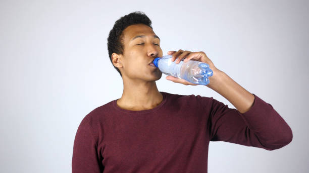 istock Thirsty Man Drinking Distilled Water from Bottle, Feeling Satisfied 836113286
