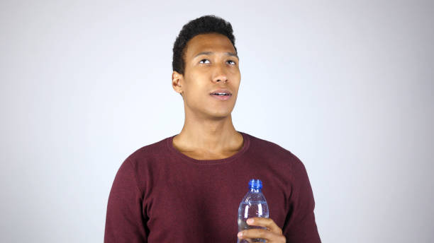 istock Afro-American Man Relaxing after Drinking Water from Bottle, Feeling Satisfied 836113290