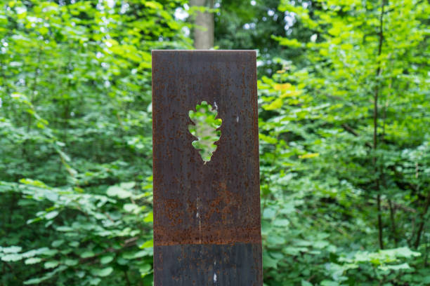 rusty metal flower sculptures in forest with tree background