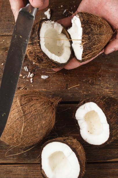 istock Coconut broken by knife on wooden background 836128212