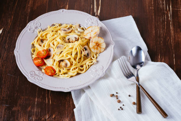 istock Creamy Italian pasta with mushrooms, tomatoes 836128764