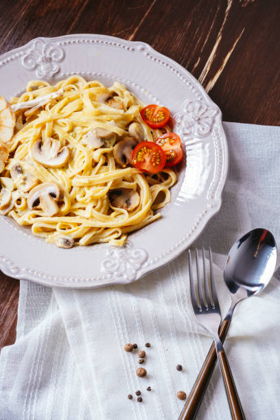 istock Creamy Italian pasta with mushrooms, tomatoes 836128798