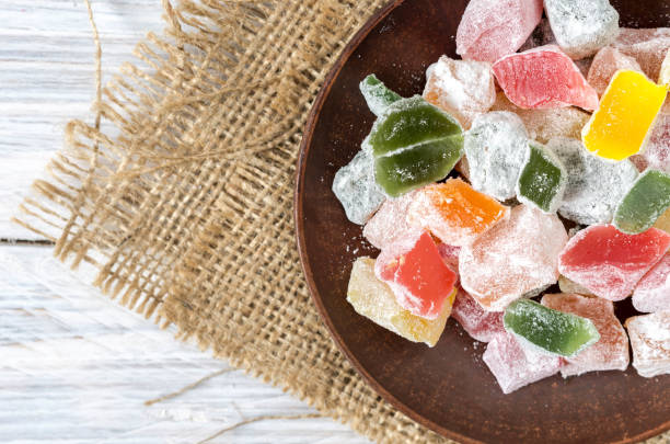 istock Multicolored sweets, marmalade on a clay plate. Background of burlap. Rustic style. 836131070