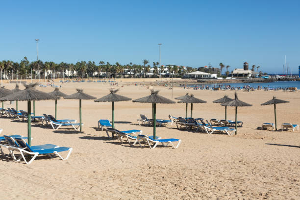 Sun lounger on the beach of Caleta de Fuste, Canary Island Fuerteventura, Spain stock photo