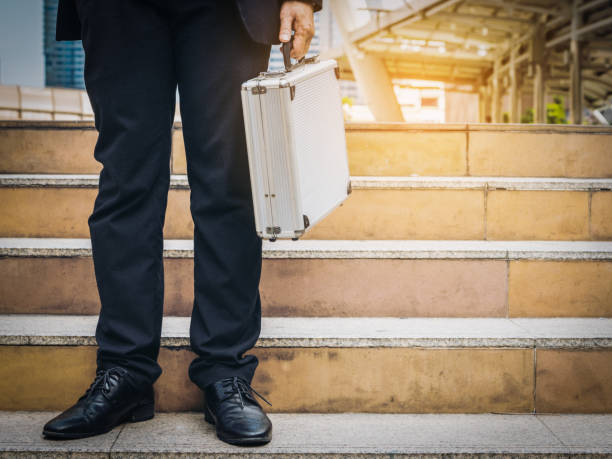 istock Business man holding metallic briefcase 836133154