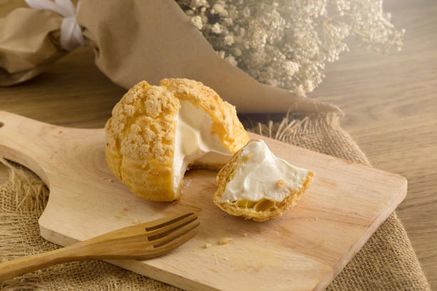 istock Choux Cream on plate. Cream puffs filled vanilla and milk custard 836136076