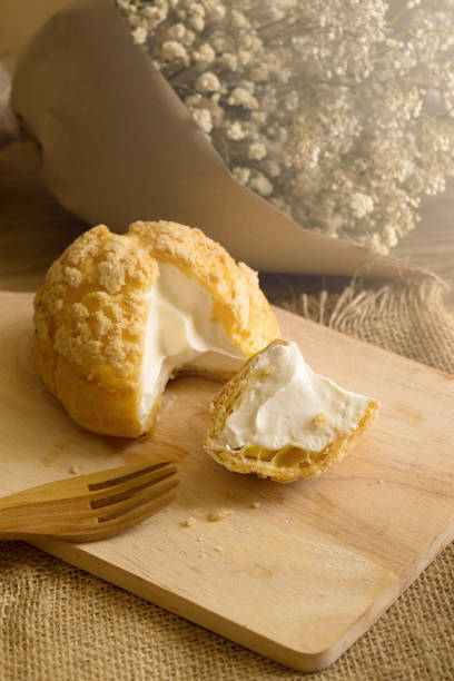 istock Choux Cream on plate. Cream puffs filled vanilla and milk custard 836136098