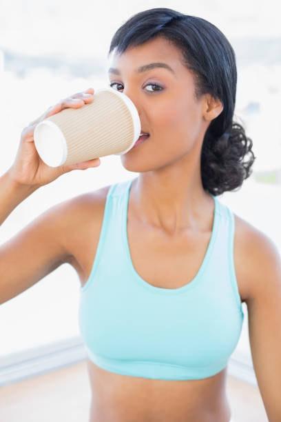 istock Attractive black haired woman drinking coffee 836139344