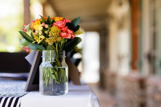 Flower decoration on a table at a wedding with blurred background