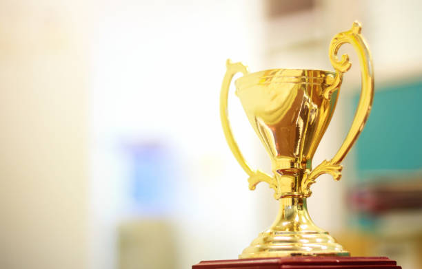 istock closeup gold trophy with soft-focus and over light in the background 836143188