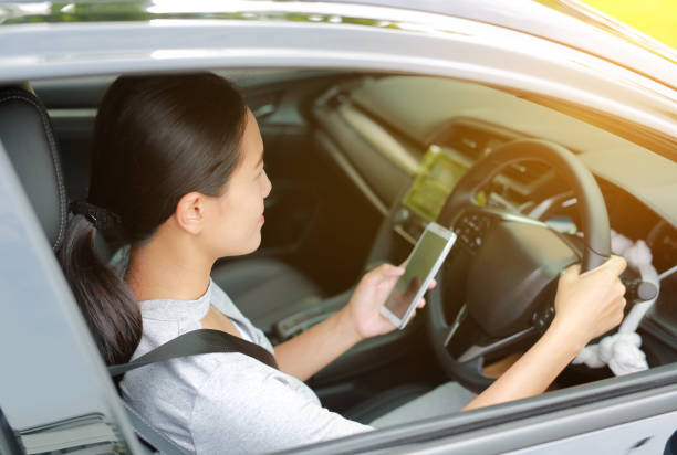 istock Woman driver using smart phone in car. 836151424