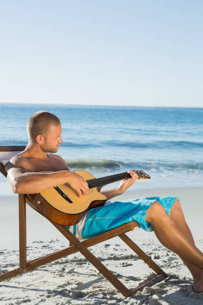 istock Focused handsome man strumming guitar 836154628
