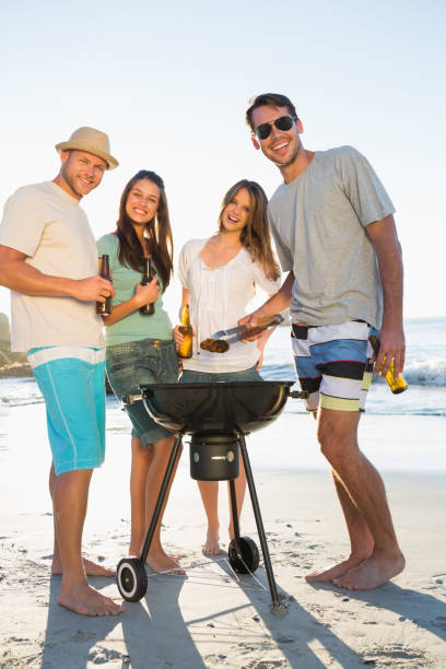 istock Happy friends looking at camera while having barbecue together 836155032