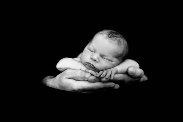istock Beautiful baby boy, sleeping peacefully in fathers hands, infant sleeping 836157702