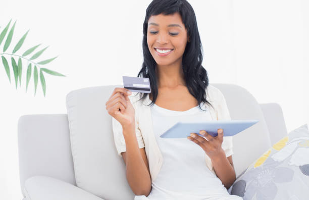 istock Delighted black haired woman buying online with her tablet pc 836167622