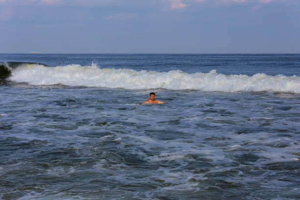 istock middle-aged man in the waves of the atlantic ocean 836179318
