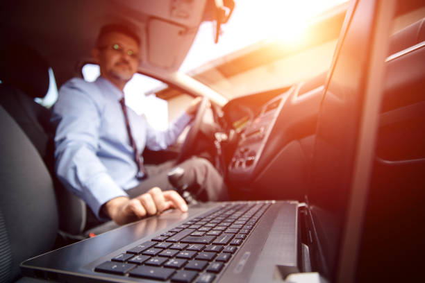 istock Businessman is typing on the laptop in a car. 836179942