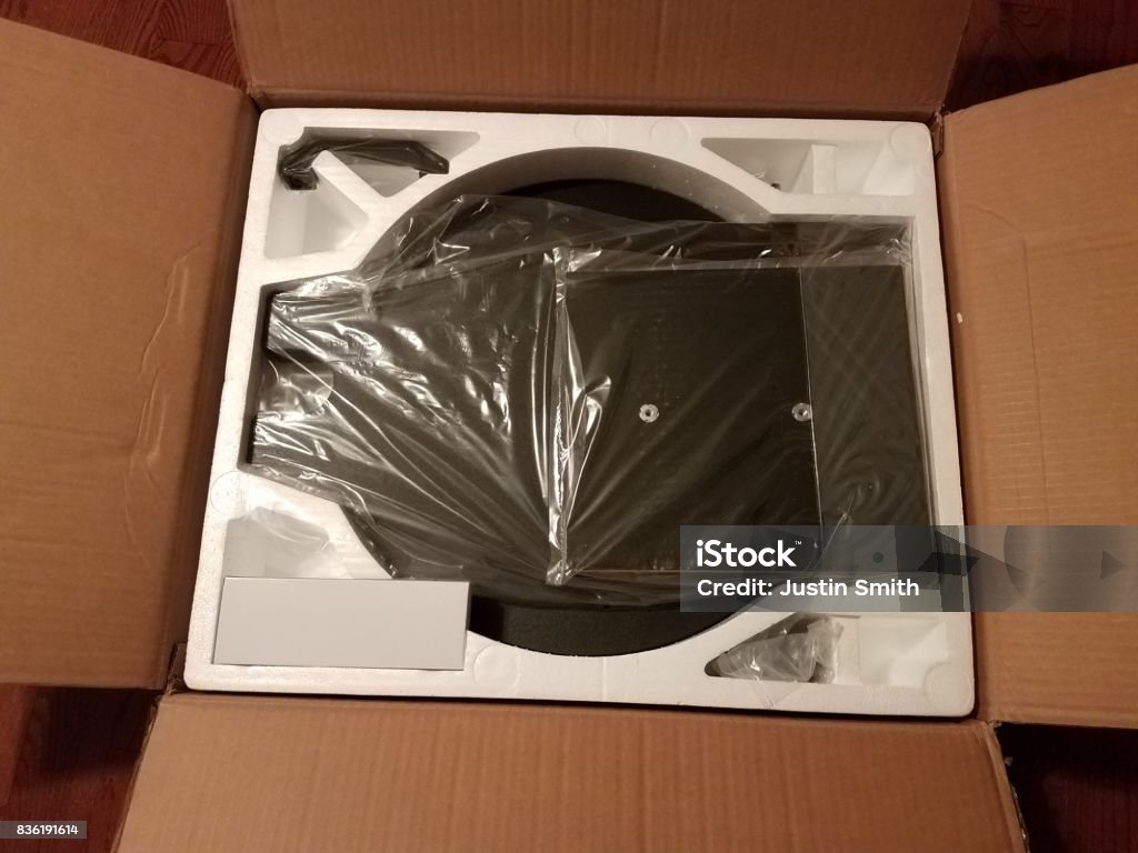 base of a Dobsonian telescope in a box base of a Dobsonian telescope in a cardboard box Astronomy Stock Photo