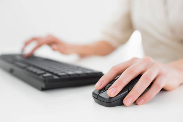 istock Midsection of a businesswoman using keyboard and mouse 836199492