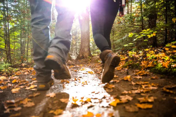 Photo of Young couple hiking in mountain on a footpath in Canada
