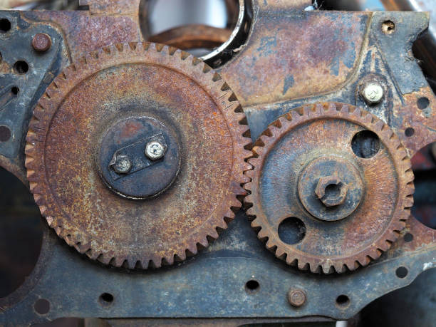 istock Two connected steel cogwheels linked together over a grungy steel background 836201768