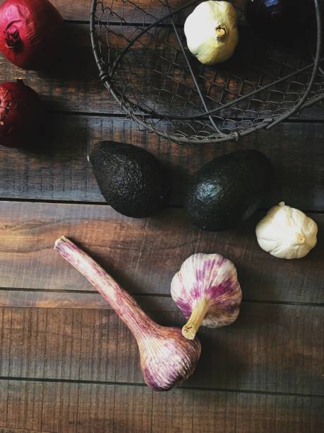 istock Purple garlic and avocados on wooden table 836204580