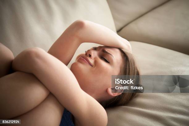 Stressed Lady Lying On Couch At Home And Crying Stock Photo - Download Image Now - Sadness, Women, One Woman Only