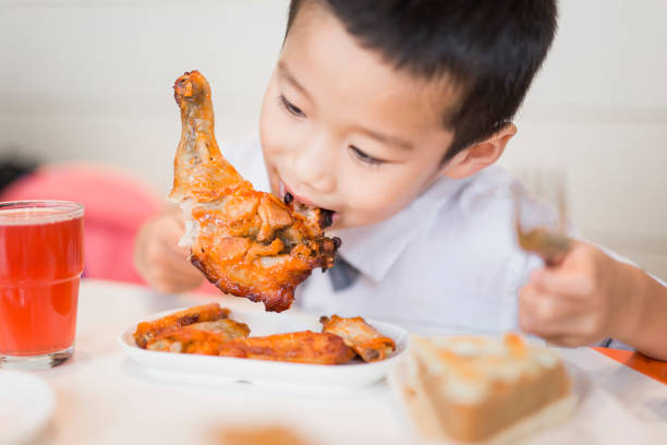 istock Chinese boy eating chicken leg 836226936